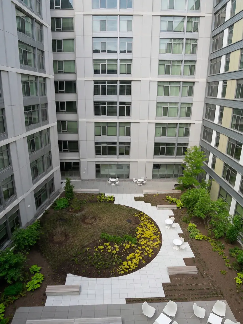 Aerial view of a courtyard garden with a circular lawn and seating