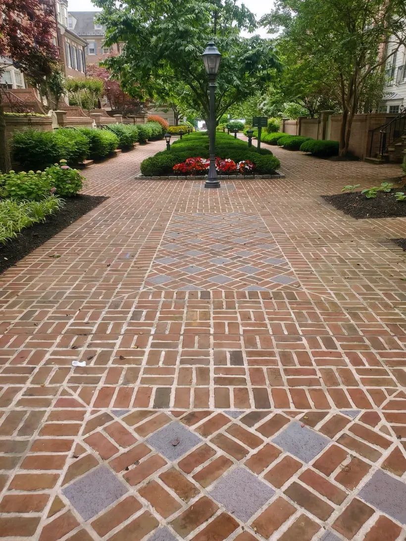 Brick courtyard with flower beds and a garden lantern