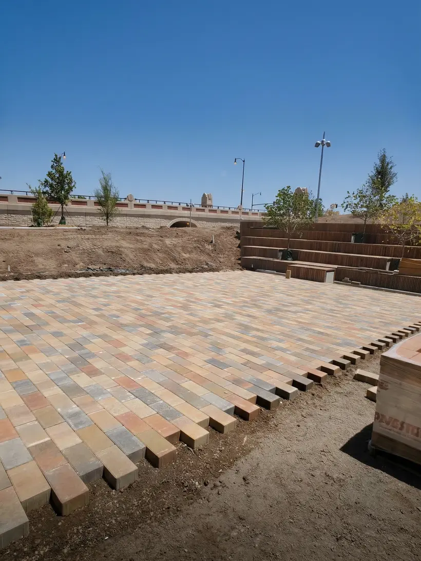 Paver terrace at golden hour with planted beds and benches