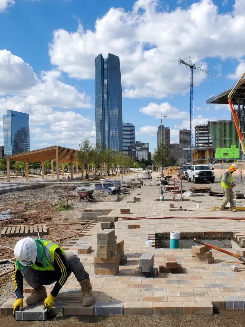 Paver crew with the downtown skyline behind