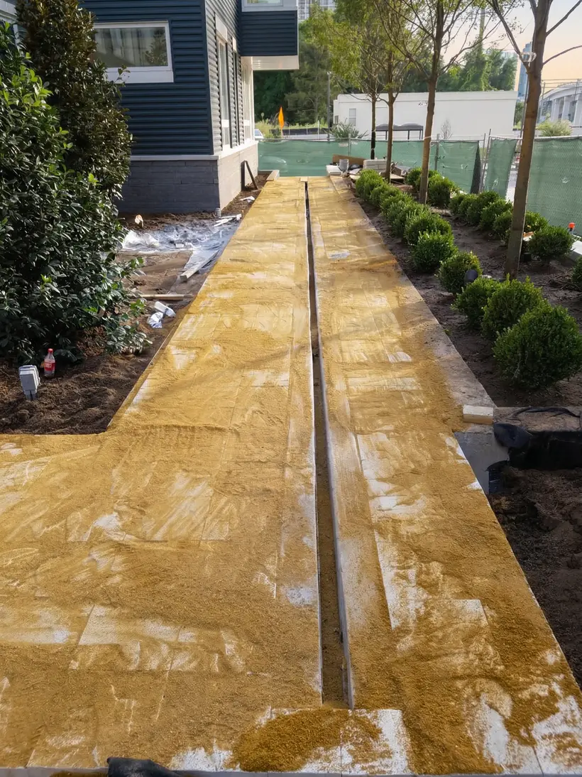 Path layout staked with string guides on graded soil
