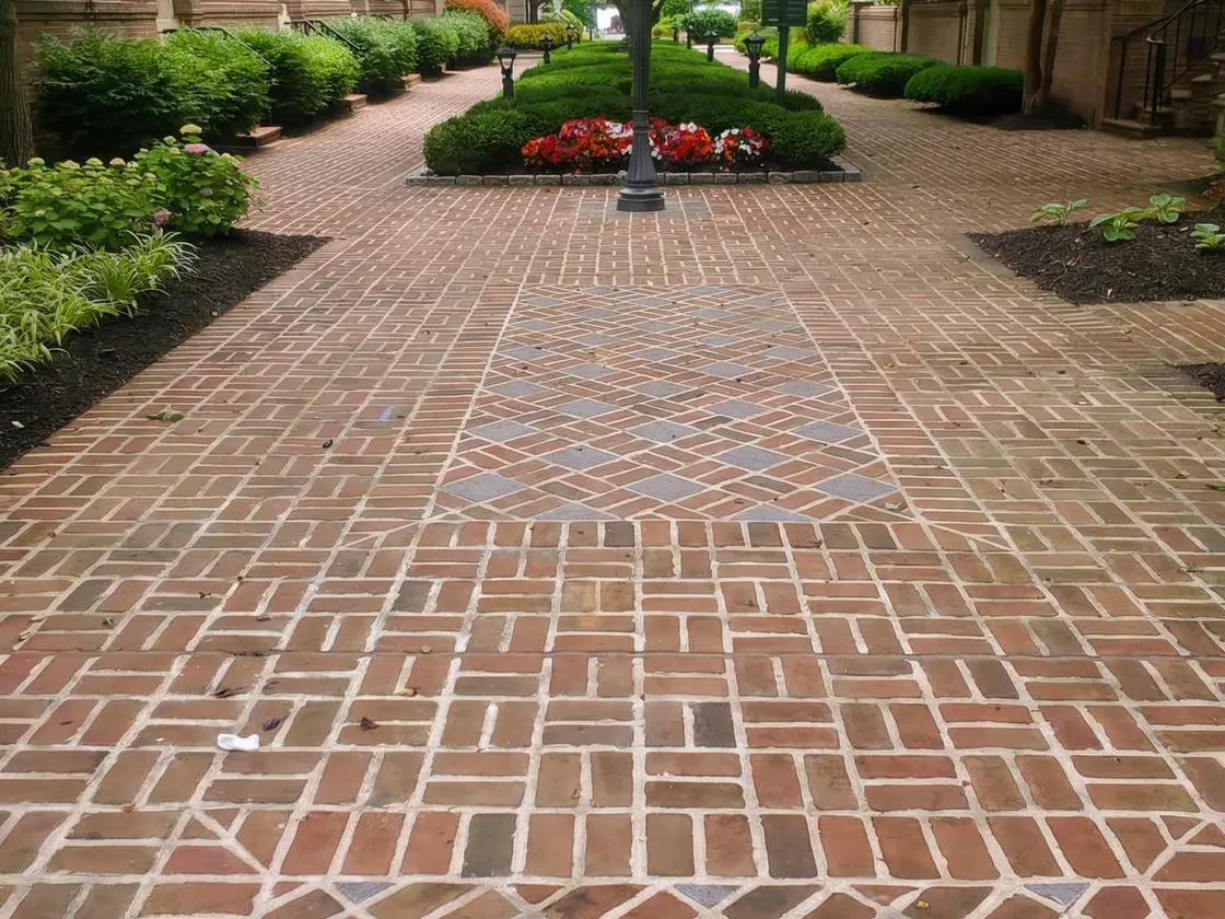 Brick courtyard with planted beds and a garden lantern built by Keystone